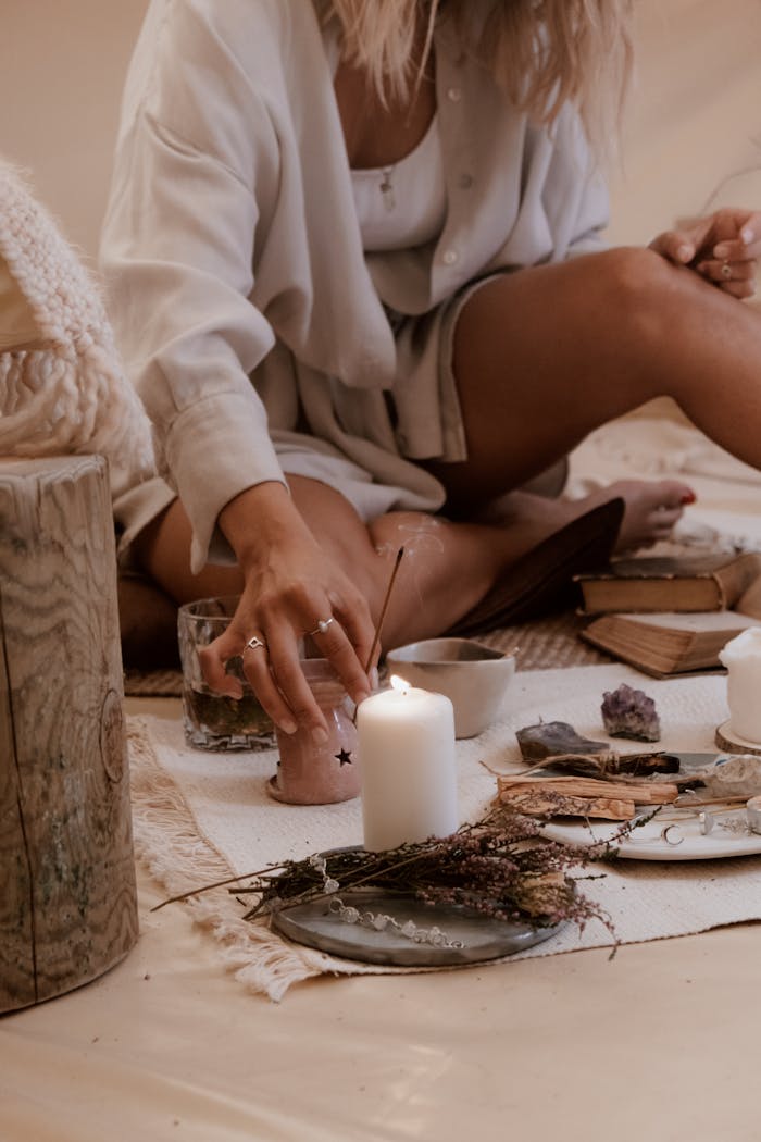 Cozy indoor scene of relaxation with candles, crystals, and incense for a soothing meditation routine.